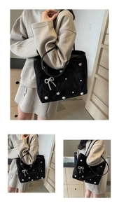 Detail of black velvet tote bag with sparkling rhinestone bow and white pearl accents