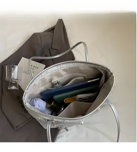 Top view of silver tote bag interior showing large capacity with pockets and pearl accents