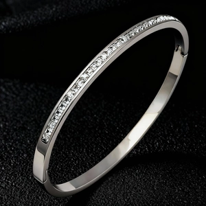 Detailed view of titanium steel bracelet with channel-set square sparkling zircons
