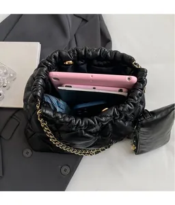 Interior view of black quilted tote bag showing large capacity for tablet and notebook