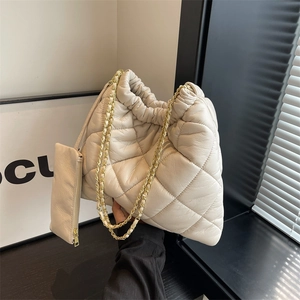 Beige quilted shoulder bag with gold chain strap and matching small zipper pouch