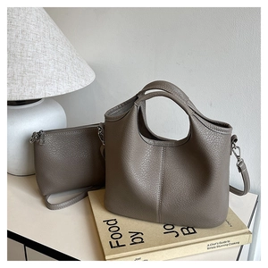 Detail of taupe bucket bag with matching pouch and detachable wide shoulder strap