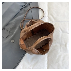 Top view showing the spacious interior and magnetic closure of the brown bucket bag