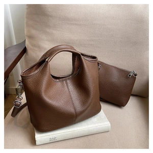 Detail of brown litchi pattern leather tote bag set with matching zipper coin pouch