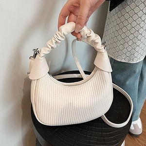 Creamy white pleated crescent hobo bag with scrunchie handle and adjustable strap