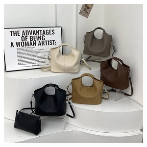 Detailed view of bucket bags in five colors with textured faux leather and shoulder straps