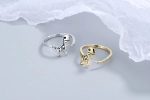 Macro detail of S925 sterling silver stamp on golden dinosaur skeleton rings