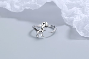Detailed view of silver dinosaur ring showing intricate scales and adjustable band