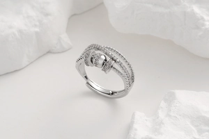 Detailed close-up of a silver-toned zircon multi-layer ring with rotatable beads