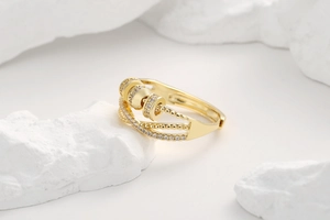 Detailed close-up of golden spinning fidget ring with pavé cubic zirconia on stone base