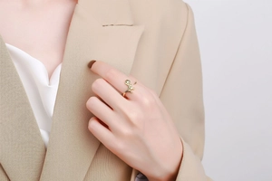 Close-up of golden dinosaur ring featuring detailed T-Rex bones and adjustable band