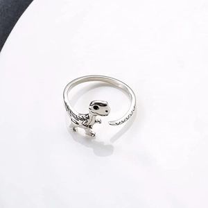 Detail view of adjustable dinosaur open ring with polished T-Rex design and black accents