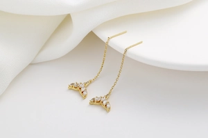 Detailed view of dangling mermaid tail earrings with white zircons and long tassels