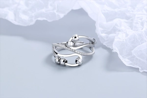 Macro shot of silver kinetic spinner beads on a layered braided adjustable open ring