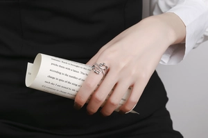 Detail of silver multi-layer interlocking ring with movable beads worn on finger