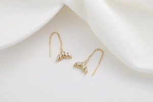 Detailed view of elegant gold mermaid tail drop earrings with sparkling marquise zirconia