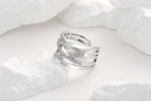 Detailed view of criss-cross layered silver ring featuring micro-pave white zircon stones