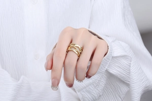 Close-up of golden crisscross ring with micro-pave crystals on a model finger