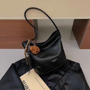Retro black faux leather hobo bag with teddy bear charm and woven details