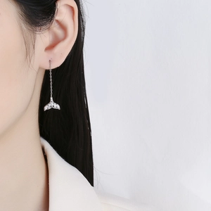 Sparkling mermaid tail earrings with silver ear threads and zircon stones on model