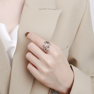Adjustable silver multilayer spinning bead ring worn on finger with elegant beige styling