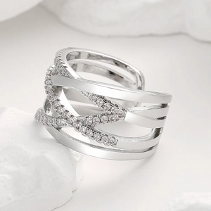 Minimalist silver crisscross ring featuring micro-paved rhinestones on a stone base