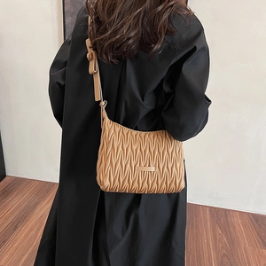Close-up of brown pleated PU leather shoulder bag featuring a stylish ruched design