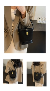 Detail of black vintage bucket bag featuring suede leather texture and gold metal buckle