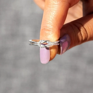 Minimalist double layer knot ring in silver finish with sparkling heart-shaped zircons