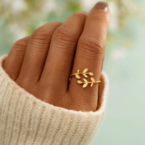 Gold leaf cross open ring with sparkling white zircon stones worn by a model