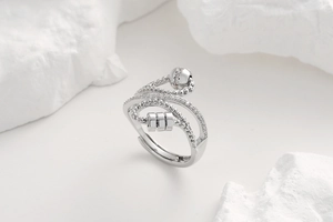 Macro detail of adjustable anxiety ring with rotating beads and white zircon stones