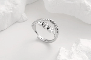 Macro shot of spinning silver ring with rotating diamond beads and paved crystals