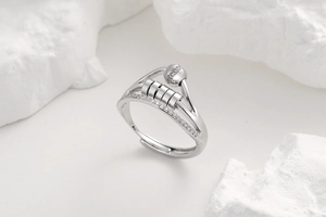Macro detail of silver anxiety ring featuring sliding metal beads and micro-pave crystals