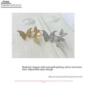 Detailed view of adjustable butterfly rings with copper gold plating and zircon inlay