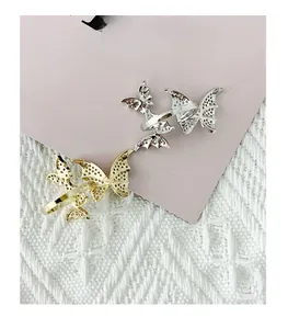 Detail of gold and silver butterfly open rings with textured micro-embossed finish