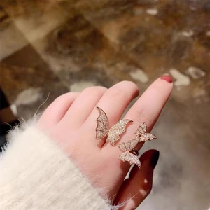 Elegant rose gold butterfly open ring with sparkling cubic zirconia on a model's hand