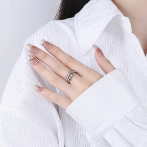 Elegant silver ring with interlocking bands and sliding beads on a model's hand