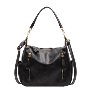 Chic black faux leather tote bag with gold zippers and adjustable shoulder strap