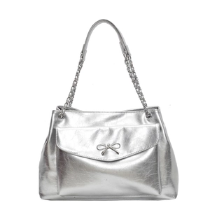 Metallic silver tote bag with front pocket, metal bow detail and chain strap on white background