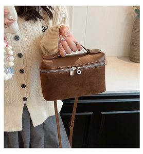 Close-up of brown vintage crossbody bag with mixed suede and smooth leather textures