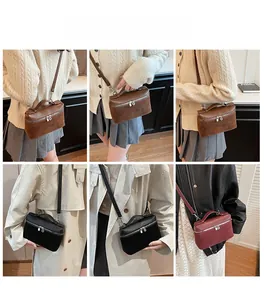 Crossbody box bag shown in brown, black, and burgundy leather on a model for scale