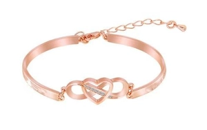 Detail of rose gold infinity heart bracelet with crystal pavé and lobster clasp