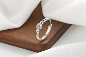 Macro detail of silver adjustable ring with circular pave cubic zirconia and bead band