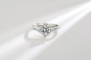 Detailed view of V-shaped crown ring with large round moissanite and micro-pave diamonds