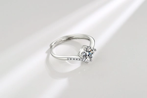 Macro shot of silver V-shape crown ring with moissanite and adjustable open band