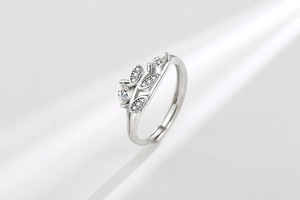 Macro detail of silver leaf ring featuring clear cubic zirconia and adjustable band