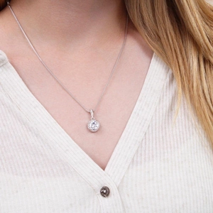 Elegant halo pendant necklace with brilliant cut center stone on a delicate chain