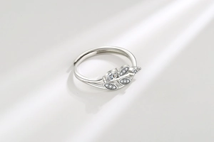 Macro detail of leaf ring showing marquise-cut zircons and polished silver texture