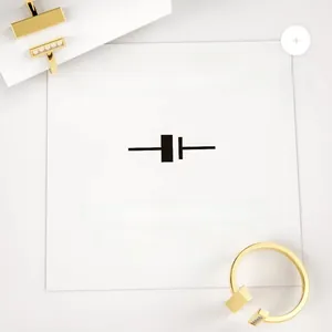 Close-up of minimalist gold T-shaped open ring with cubic zirconia inlay on white background
