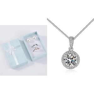 Detail of halo setting pendant necklace and assorted jewelry set in a gift box